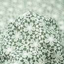 White Flower Lace Pattern on Sage Printed Spandex Fabric | Blue Moon Fabrics