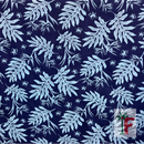 Close-up view of Coastal Canopy fabric featuring an intricate botanical print of light cyan tropical palm leaves, monstera leaves, and hibiscus flowers over a deep navy blue background.