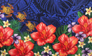 A flat-lay view of the Hibiscus, Plumeria Assortment Sarong (Style 12) featuring a vibrant Polynesian-inspired design. The pattern includes several large, bright red hibiscus flowers with yellow centers and smaller white and yellow plumeria blossoms. The background is a deep royal blue, adorned with intricate traditional Polynesian tribal motifs, stylized green palm fronds, and three golden-orange sea turtles (honu) swimming across the left side.