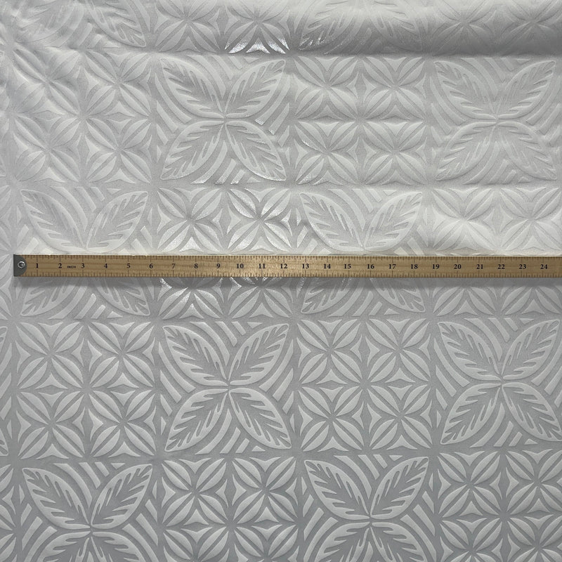 White on white foil fabric with a measuring stick 