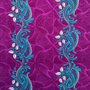 Teal and white paisley pattern on a purple background