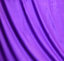 Solid purple rayon challis fabric draped in soft, spiral folds. 