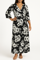Hibiscus Cluster Rayon Challis Fabric in black and white, shown as a maxi wrap dress for tropical summer fashion.