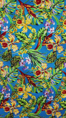 Video closeup of tropical Hawaiian orchid print fabric in Kai Aqua blue with yellow florals and palm fronds.